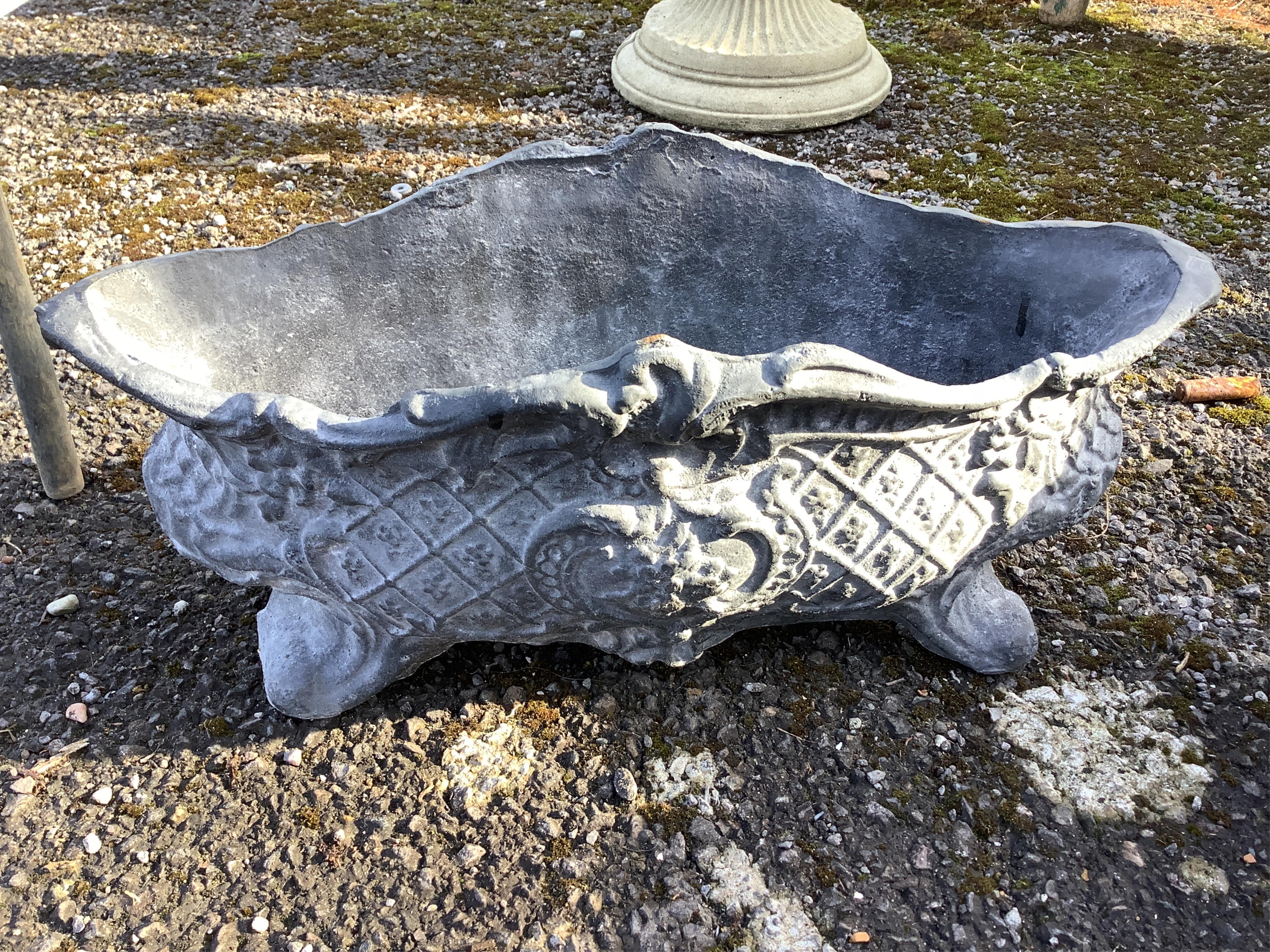 A set of four cast iron planters, width 36cm, and a pair of more ornate planters, width 48cm. Condition - weathered, otherwise good